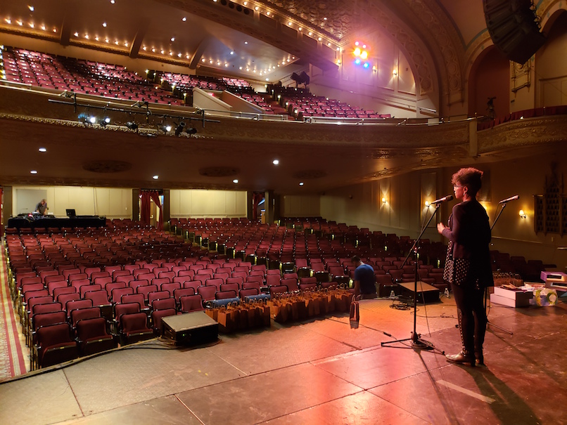 Rachelle Chase on stage in empty Hoyt Sherman Theater